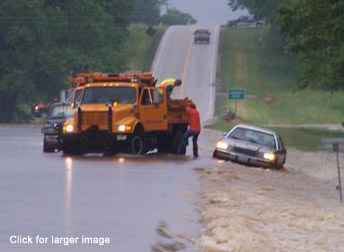 State highway workers rescueing motorist